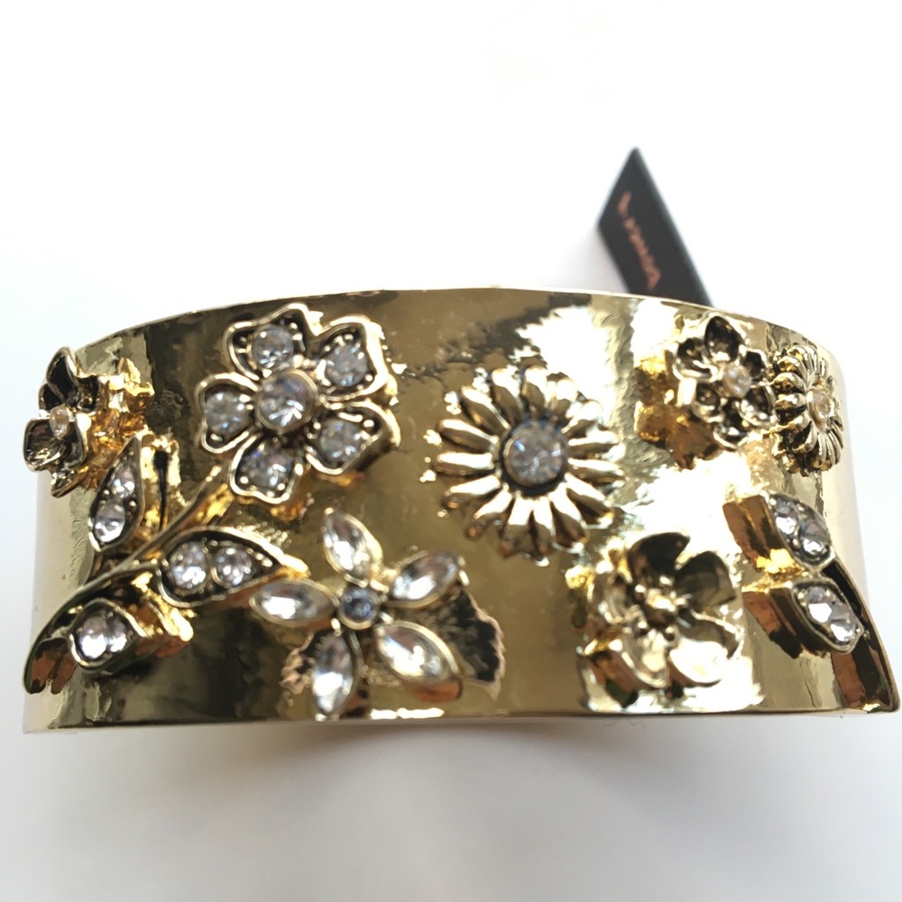 gold toned wide cuff bracelet with flowers and crystals